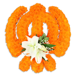 At the heart of this composition is a sacred Sikh emblem brought to life through floristry: a densely formed Khanda sculpted from velvety orange marigold heads, each bloom placed to build a full, tactile surface that glows under soft lighting. The compact marigold texture feels almost soft to the touch in appearance, and the vivid orange carries an immediate warmth. Anchoring the lower center, two or more pristine white lilies open their petals with elegant clarity; their subtle fragrance and visible yellow-green stamens lend calm and balance to the exuberant marigold field. Interspersed around the lilies are glossy green leaves-salal-style foliage-and delicate sprays of snow-white gypsophila that drift like breath through the composition, softening edges and adding depth. A faint drop shadow beneath the assembly hints at a freestanding memorial or ceremonial piece, carefully photographed on a clean white surface to emphasize form and detail. As a Stanmore florist's arrangement, created by Flower Delivery Stanmore for local observances, it's the sort of tribute you might see placed at a community gathering near Stanmore tube or carried into local cultural halls for Vaisakhi and Gurpurab. The overall mood balances joyous celebration and solemn respect-the bright marigolds convey communal spirit while the lilies and soft foliage invite contemplation-demonstrating thoughtful floral craft suited to both festive and reflective occasions.