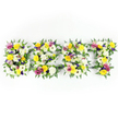 A horizontal tribute spells out the word BEST in four generous capital letters, each letter formed from a dense tapestry of fresh blooms and deep green foliage against a pure white background. Close inspection reveals large, multi-petaled white chrysanthemum-like flowers and creamy gerbera faces tucked next to sunny yellow roses and yellow gerbera daisies, their petals catching the bright, even studio light and seeming to glow. Pockets of soft lavender and mauve lisianthus thread through the yellow and white, while vivid magenta-pink spray roses or carnations create lively punctuation across each letter. Sprays of tiny pale green and white filler flowers add delicate texture and gentle contrast, giving the letters a layered, sculptural depth. Dark green fern fronds sweep around the outer edges, softening the letterforms and offering a natural frame that offsets the vibrant petals. A subtle dark green metal support is visible through small gaps, especially along the horizontal bar of the E and T, hinting at the careful engineering that lets these voluminous letters remain stable without appearing mechanical. The overall impression is one of respectful celebration - a bright, uplifting memorial or tribute piece that reads as both handcrafted and composed with restraint. The scent would be quietly floral: the honeyed warmth of roses balanced by the clean, green lift of chrysanthemums and fern. Shot head-on with crisp lighting, the display conveys clarity, reverence, and a comforting brightness suitable for remembering someone fondly while also evoking quiet joy.