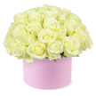 A beautifully rounded dome of creamy white roses spills softly over the rim of a pastel pink hat box, the entire creation set against a clean white background that frames it like a portrait. The bouquet is composed of dozens of roses, each bloom gently opening into layered spirals of velvety petals. Their colour palette is serene and refined: cool ivory and warm cream blend seamlessly, with the faintest trace of buttery yellow glowing at the heart of some blossoms, hinting at freshness and vitality. The flowers are arranged tightly together, creating a plush, cushion-like surface that feels indulgent yet meticulously ordered. Tiny glimpses of fresh green foliage emerge from the base, adding just enough contrast to suggest living stems and careful handwork beneath the luxurious surface of petals. The cylindrical hat box is a soft blush pink with a smooth, matte finish, reminiscent of a high-end gift you might pick up before heading to an anniversary celebration in Stanmore, perhaps near the greenery of Canons Park. Its simple, modern shape allows the floral dome to take precedence, giving the overall arrangement a chic, contemporary feel. The neutral white background and soft, even lighting bring forward every curl of petal and subtle shade change, highlighting the thoughtful craftsmanship involved. This image speaks of moments worth cherishing-an elegant anniversary surprise delivered to a doorstep on a quiet Stanmore cul-de-sac, a romantic gesture left waiting on a bedside table, or a stylish centrepiece at an intimate dinner-capturing love, gratitude, and celebration in a single, beautifully considered floral design.