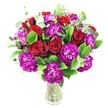 This arrangement is a celebration of contrast and warmth: deep, velvety red roses sit amid a generous spray of magenta-purple carnations, their frilled, almost ruffled petals catching the light and creating lively movement. A handful of the roses are still tightly furled while others are just beginning to unfurl, revealing layers of plush, spiralled petals that suggest classic romance. Bright, glossy green foliage-likely ruscus-forms a lush, supportive canvas around the blooms, while slender, silvery eucalyptus sprigs thread through the composition and lift the palette with a contemporary, cooling note. The flowers are arranged as a dense, rounded cluster in a simple clear glass vase so that the clean, straight stems are visible through the water, contributing to an overall feeling of freshness and honest craftsmanship. Photographed against a pristine white background, the intense crimson and fuchsia tones read with strong clarity and the subtle sheen on the leaves adds a dewy, morning-fresh impression. The scent, if you can imagine it, would be a soft mingling of warm rose and crisp eucalyptus-comforting, familiar, and quietly celebratory. This bouquet feels equally at home on a dining table for an anniversary or as a heartfelt delivery to mark a birthday or achievement. As a Stanmore florist, I picture this sent from a shop near Stanmore High Street or carried from Canons Park, chosen by someone wanting to convey deep affection with a modern, textured twist and a respectful attention to seasonal freshness.