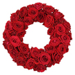 A lush circular wreath crafted entirely from dozens of deep crimson red roses, densely packed with no visible greenery, rests against a neutral light background that makes the colour sing. Each rose appears fully bloomed, its velvety petals arranged in concentric spirals that convey richness and confidence, while the smaller buds tucked here and there add a subtle, organic texture. The ring forms a hollow center, a classic silhouette that anchors the eye and gives the arrangement a ceremonial air. This timeless design carries strong associations with remembrance, tribute, and heartfelt affection, yet its generous bloom makes it suitable for romantic anniversaries, festive home décor, or a meaningful gift to a friend in Stanmore. It is available for quick delivery across HA7 and surrounding areas, bringing a wreath of warmth to a door, a hospital chapel, or a friend's living room with careful handling. The white background ensures the red tone remains dominant, inviting closer inspection of the meticulous petals and the craft that shapes every curve into a symbol of connection and care.